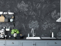 Charcoal flower pattern wallpaper on a kitchen backsplash wall with modern cabinetry.