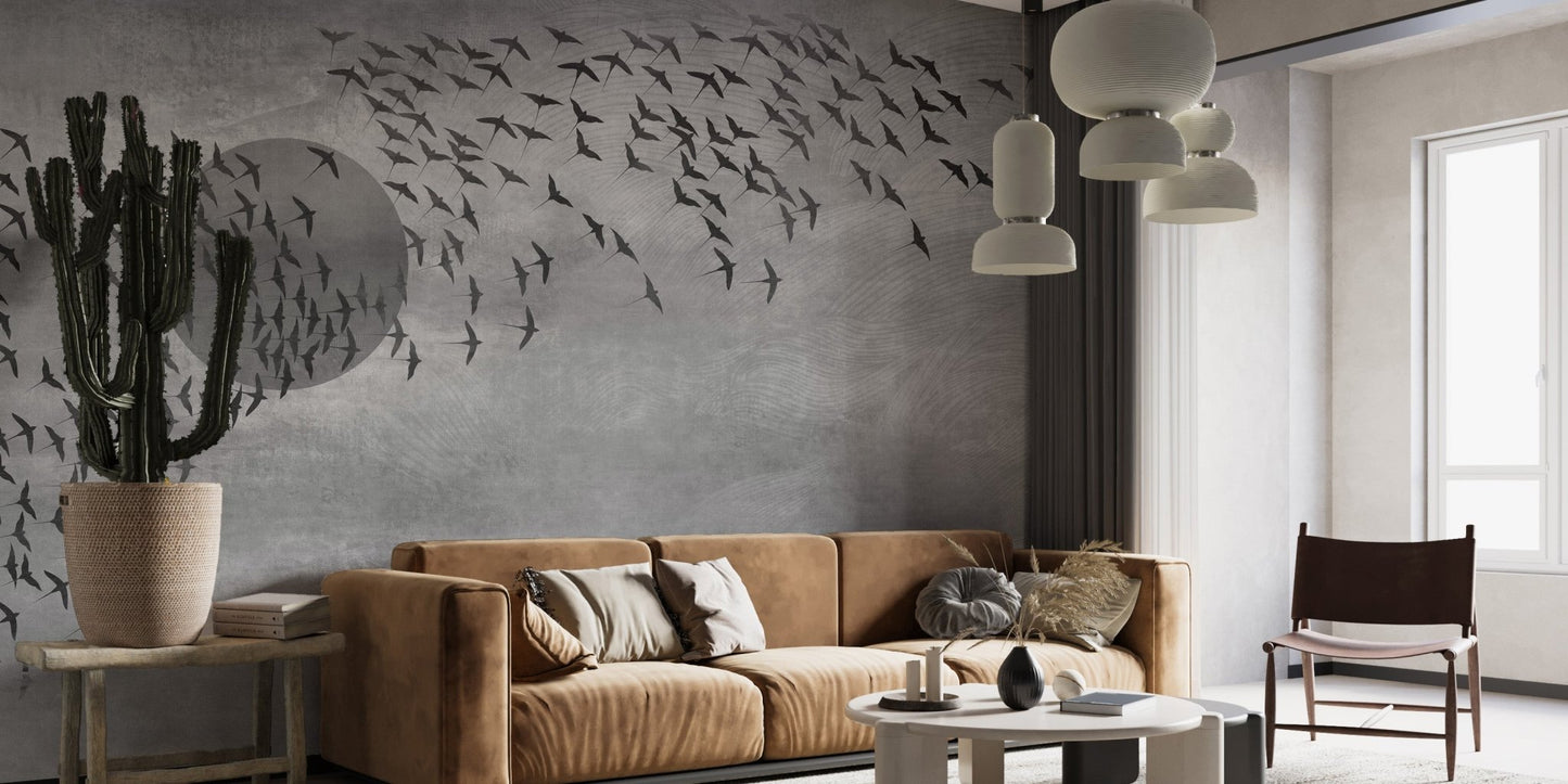 Textured grey wall mural with bird patterns in a living space with tan leather seating.