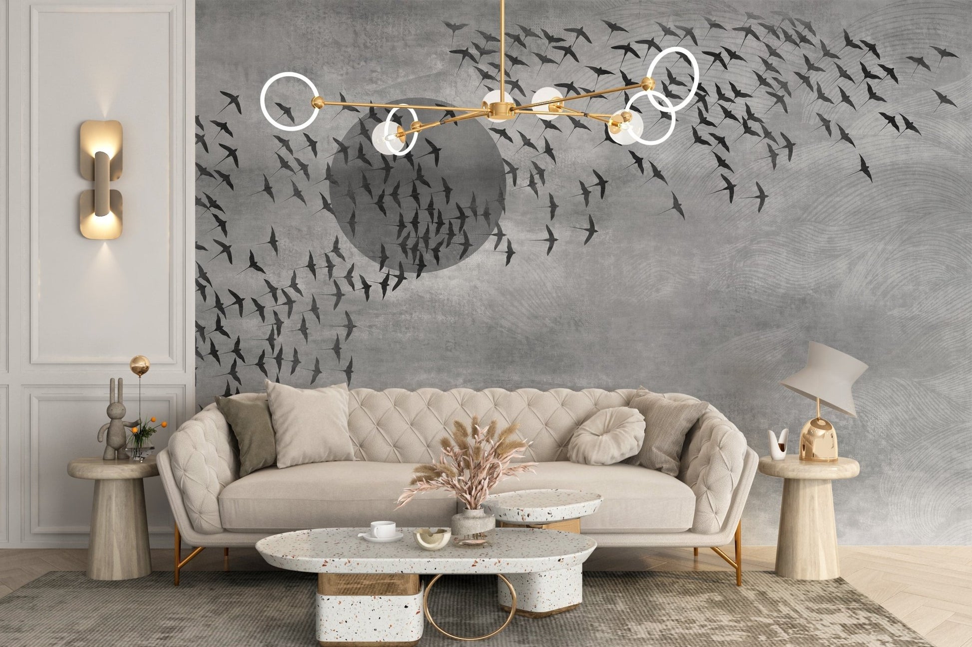 Flying birds wall mural behind a cream sofa with gold light fixtures in a living area.