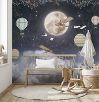 Nursery wall mural with rocking horse and bench in front of dark night design.