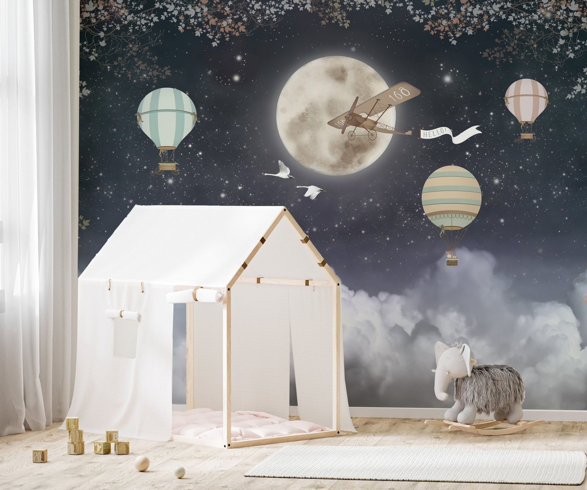 Kids bedroom mural featuring wooden house bed and celestial night sky pattern.