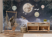 Nursery accent wall mural with moon and clouds over dark nights.