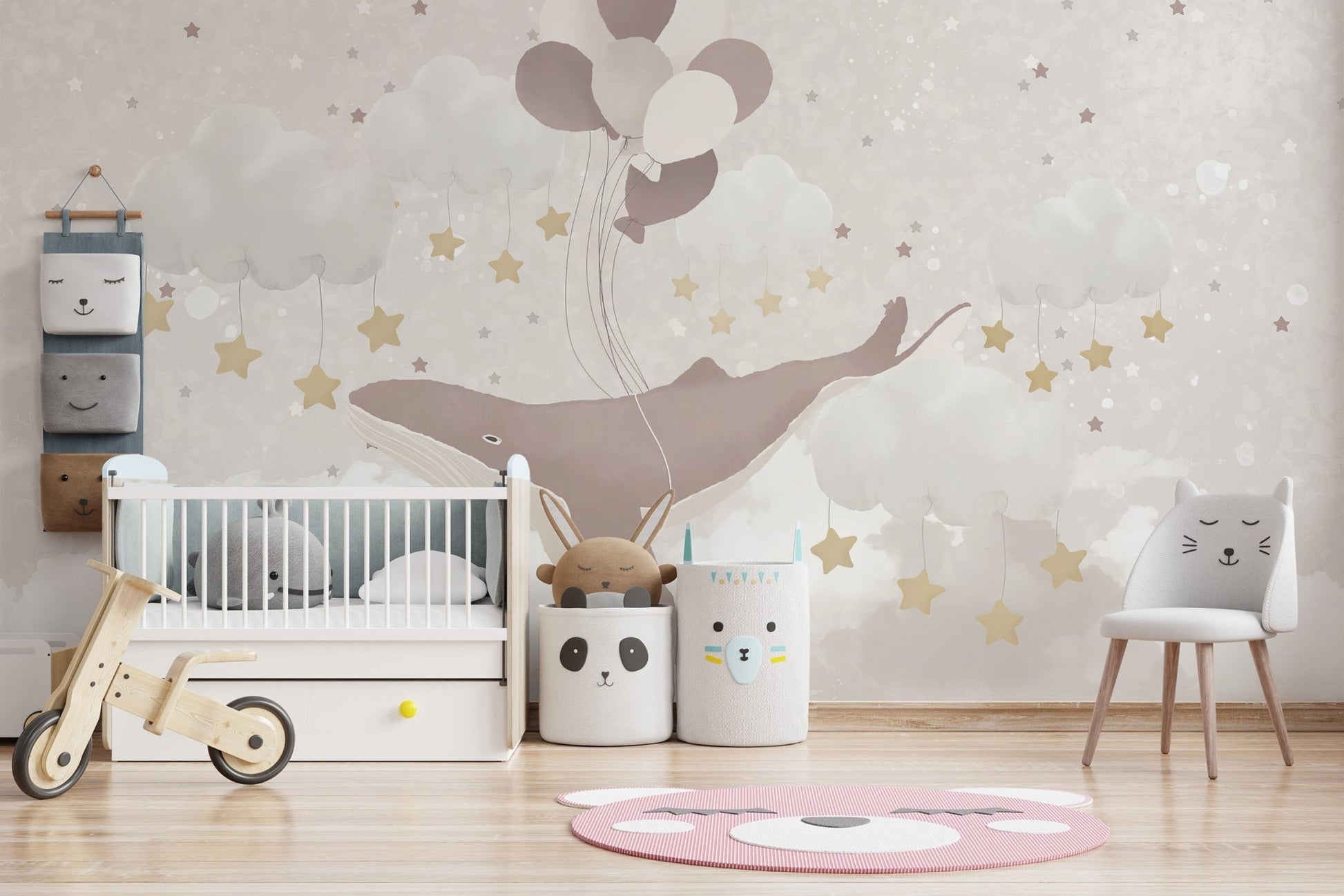 Blush and beige whale wallpaper wall mural with hanging stars.