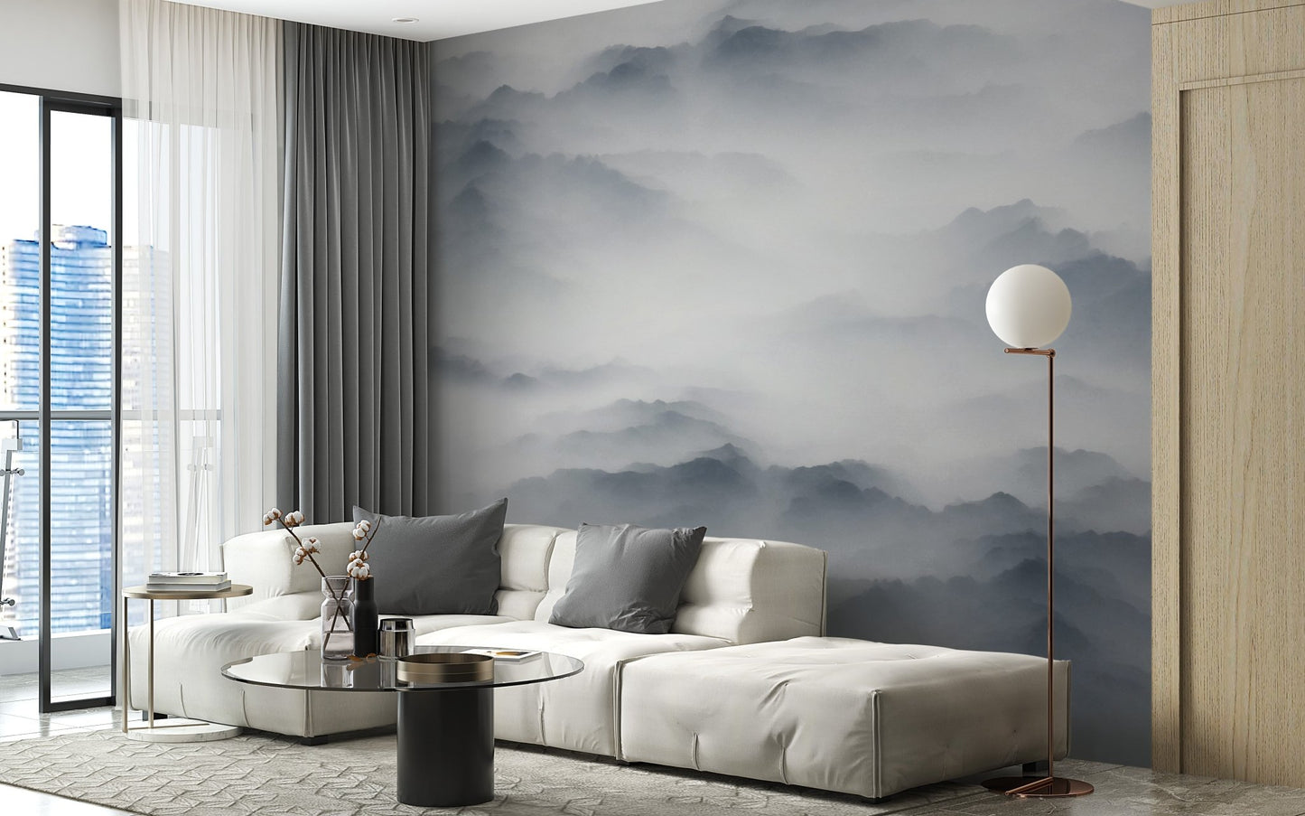 Foggy mountain range wall mural in white living room with cream sofa and tall lamp.