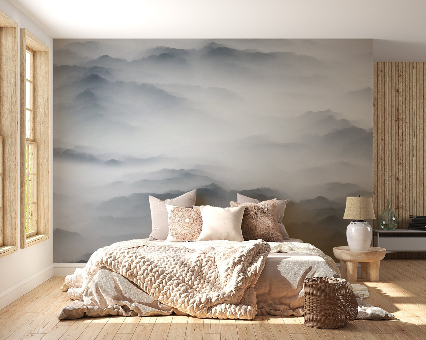 Neutral tone mountain wall mural in bedroom with light wood furniture and sunlit window.


