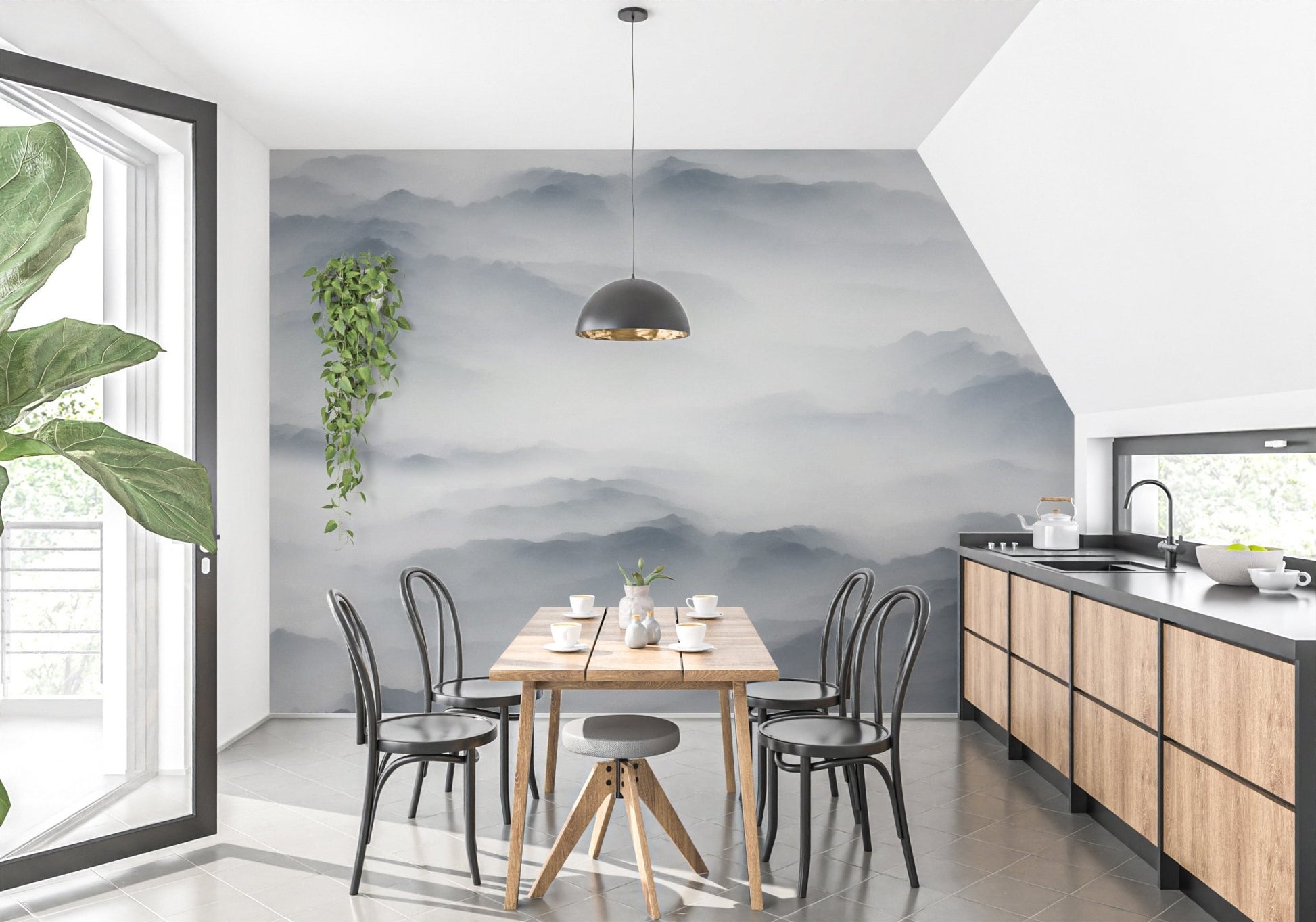Grey foggy hills wall mural in dining room with wooden table and black chairs.