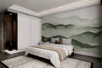 Earthy green mountain wall mural with misty sky for modern bedroom.