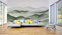Green and grey landscape wall mural showing misty peaks for living room.