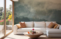 Foggy mountain wall mural behind a white sectional couch in a bright living area.