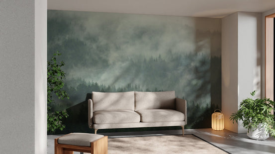 Green foggy forest wall mural in a modern living room with a tan sofa.