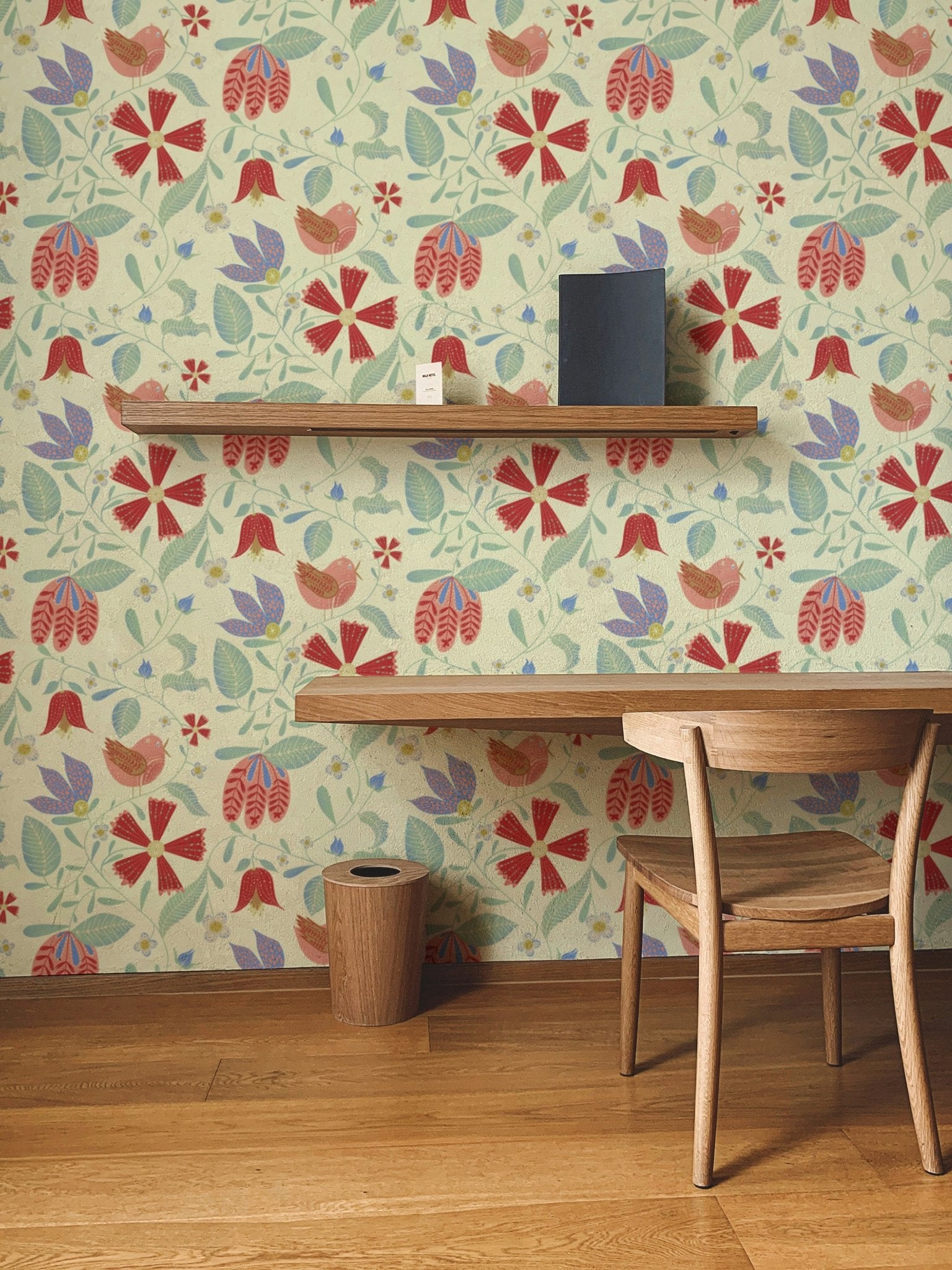 Folksy birds wallpaper with red flowers and blue vines on cream.