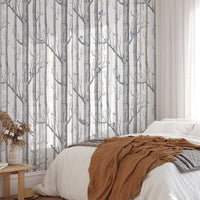 Forest White Background Scandinavian Style Wallpaper in a bedroom with brown linens.