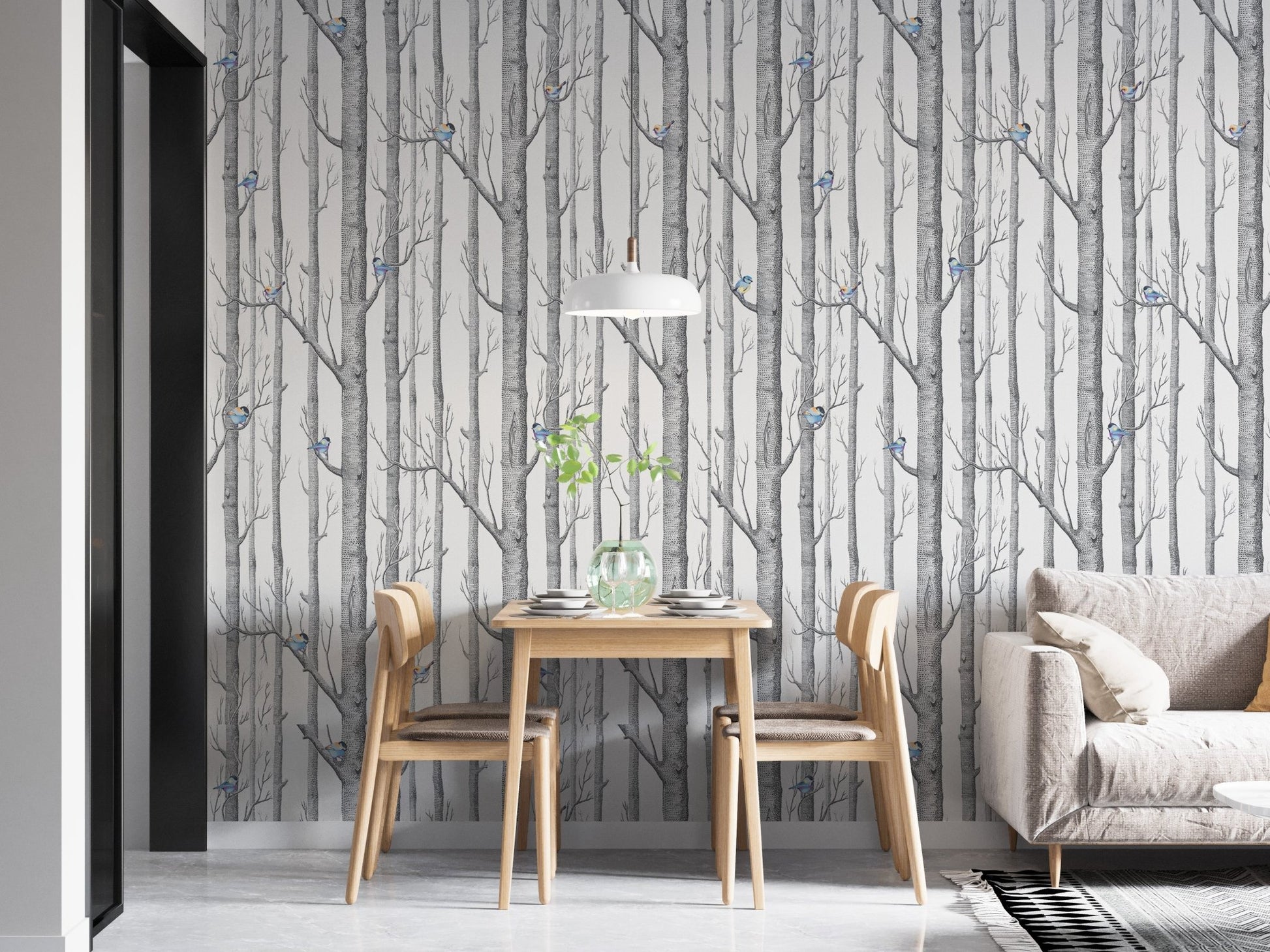 Birch forest wallpaper with small blue birds behind a wooden dining table and chairs.