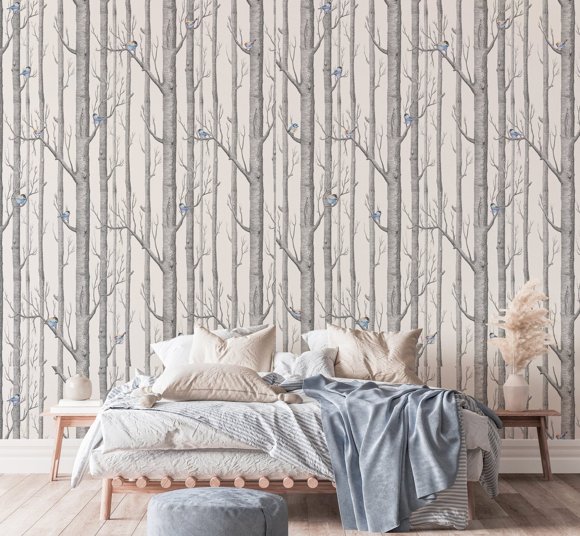 Grey and white forest wallpaper in a bright bedroom with a white bed.