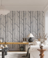 Monochrome forest wallpaper with subtle blue bird details in a contemporary flat.
