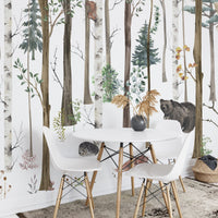 Small dining area with a woodland forest wall mural.