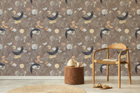 Dark brown cosmic animal wallpaper in living room with wooden chair and rug.