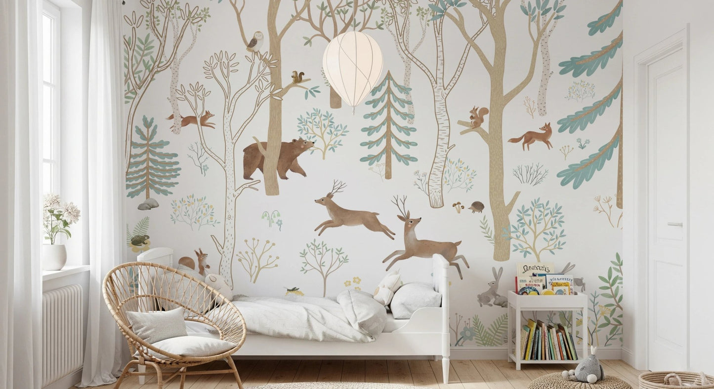 Woodland animal wall mural behind a wooden rocking chair in a childs bedroom.