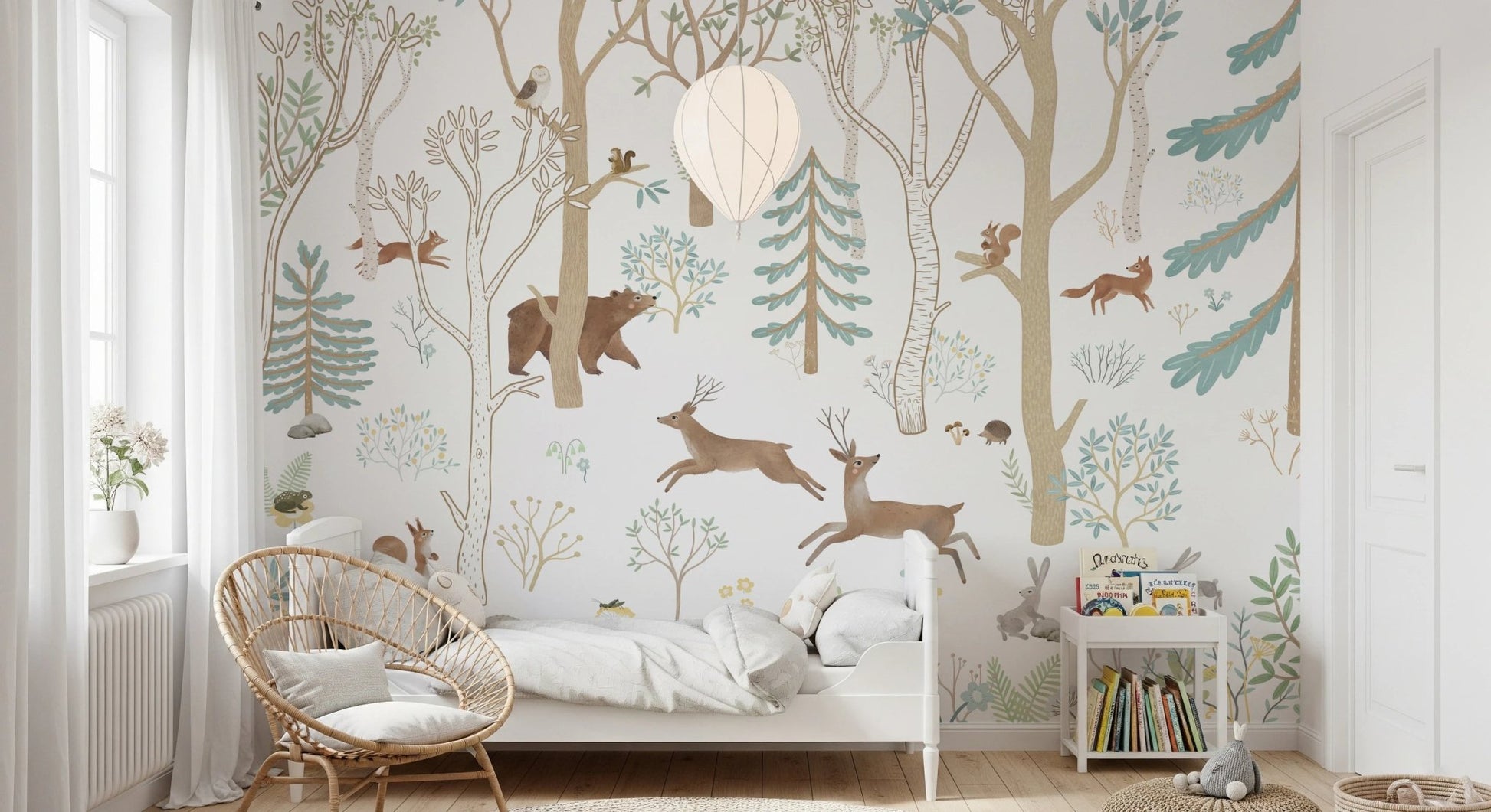 Woodland animal wall mural behind a wooden rocking chair in a childs bedroom.