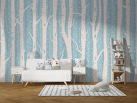 Light blue forest wall mural in a living room with white sofa and wooden floor.