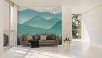 Alpine range watercolor wall mural in a bright living room with a brown sofa.