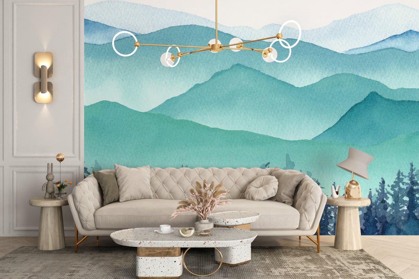 Watercolor mountain wall mural behind a beige sofa in a modern flat.