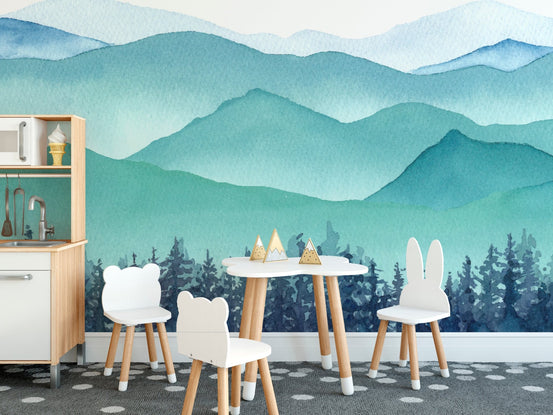Kids' dining room featuring watercolor mountain wall mural and small white chairs.