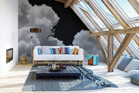 Attic living space with slanted windows and a large cloud pattern wall mural.