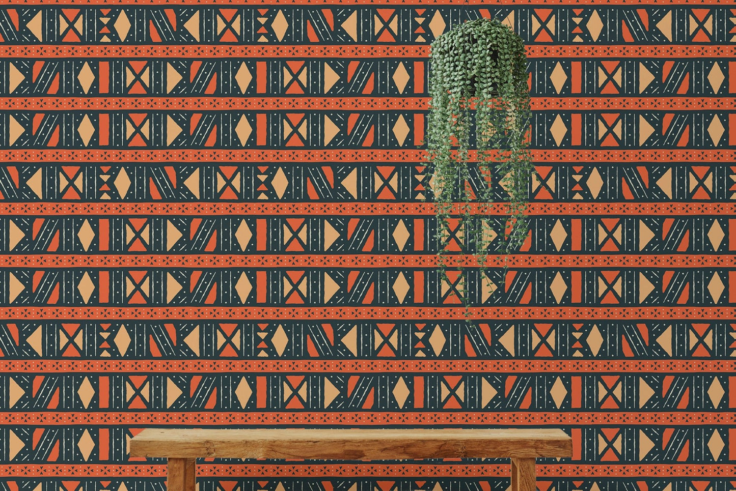 Orange and black tribal wallpaper in a room with a long wooden bench.