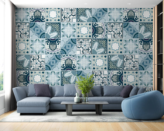 Blue mosaic tile wall mural behind an L-shaped sofa in a contemporary flat.