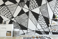 Bold black and white patterns mural with geometric designs.
