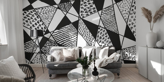 Geometrical Black & White Patterns Wall Murals in a modern living room with grey sofa.