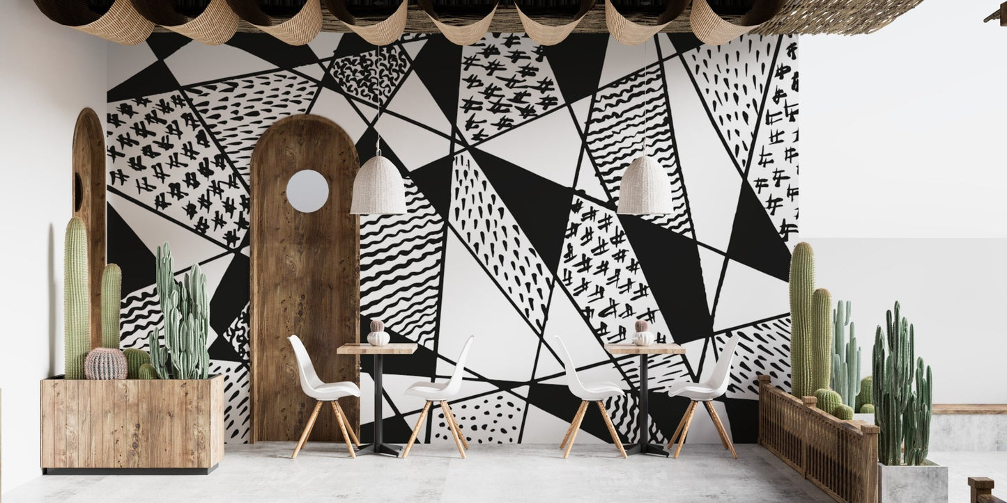 Patterned black and white mural with sharp geometric lines.
