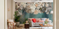Vintage floral wall mural behind a grey sofa and indoor plants.