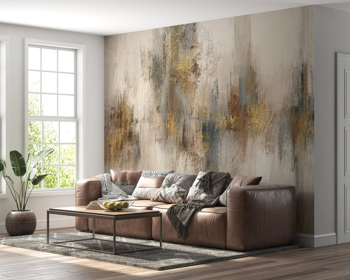 Brown leather couch against a grey and gold stroke wall mural.