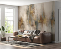 Brown leather couch against a grey and gold stroke wall mural.