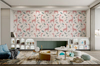 Hand-drawn pink giraffes and grey foliage wallpaper in kids playroom.