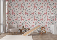 Soft pink and grey botanical wallpaper with repeating giraffes.