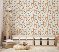 Cartoon giraffe pattern wallpaper with green leaves on cream background.