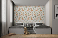 Minimalist animal wallpaper with soft leaves and brown giraffes in bedroom.