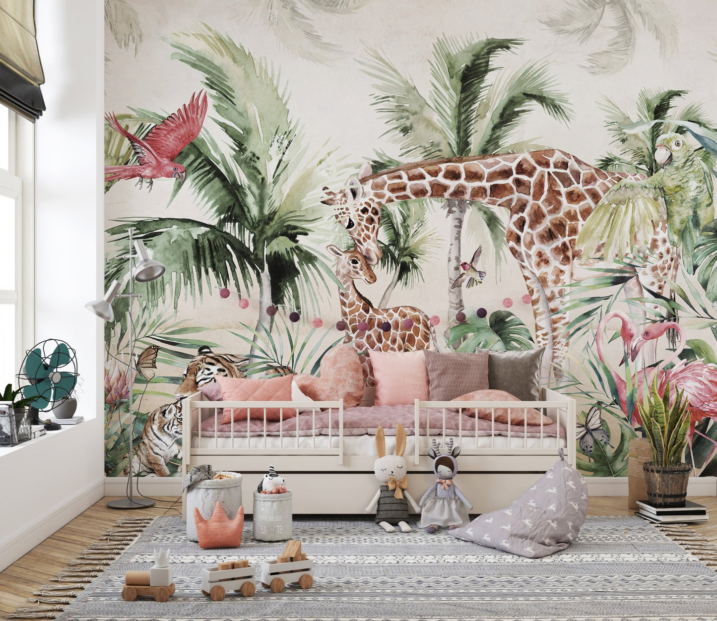 Soft green and beige forest wall mural behind a white toddler bed with pillows.