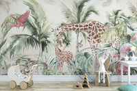 Nursery wall mural showing giraffes and tropical greenery behind a white wooden table.