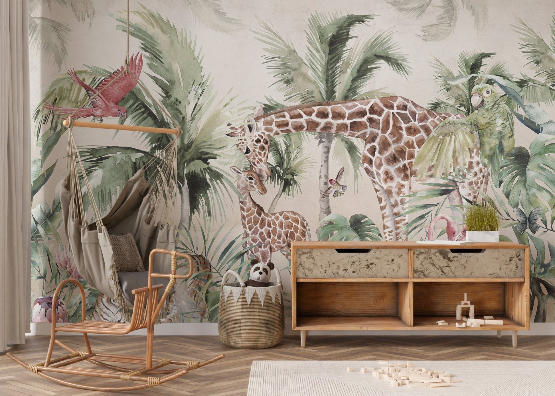Watercolor palm leaf wall mural with giraffes in a nursery featuring a wooden storage.