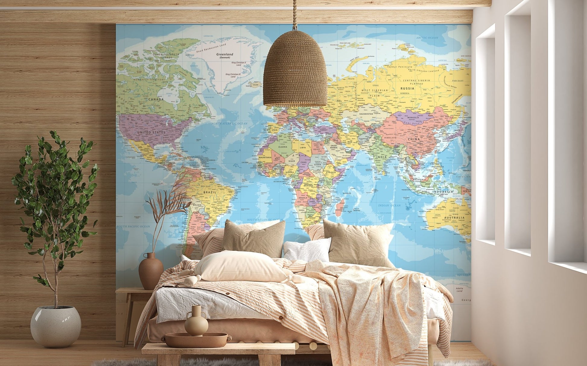 Blue world map wall mural behind a light wood bed and neutral linens.