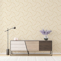 Abstract gold wave wallpaper mural behind a modern sideboard and desk lamp.
