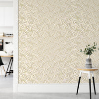 Neutral hallway wall featuring a gold geometric circle pattern wallpaper.