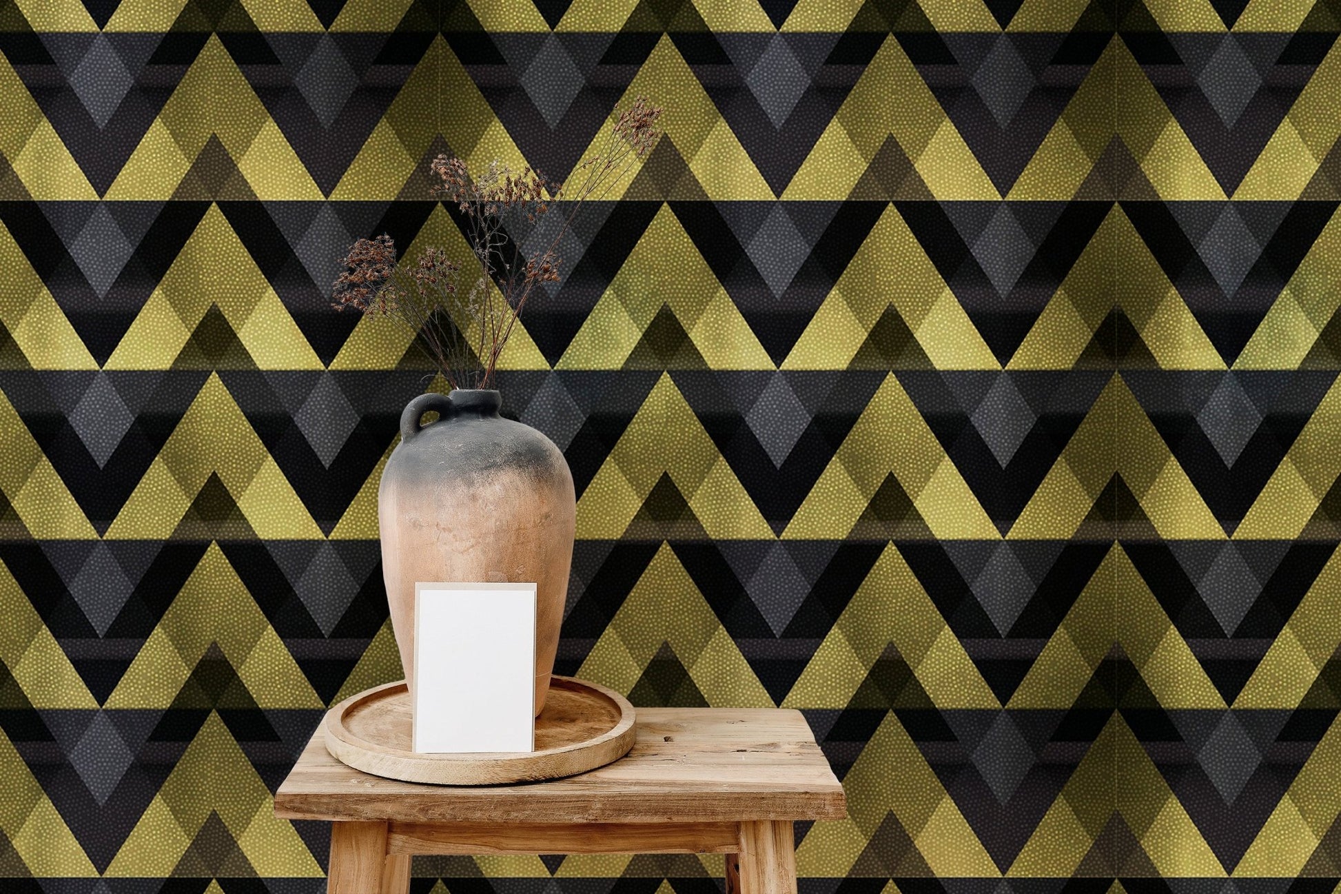 Small table in front of a gold and black geometric wallpaper.