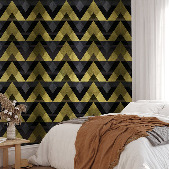 Minimalist bedroom with metallic gold zigzag wallpaper and brown bedding.