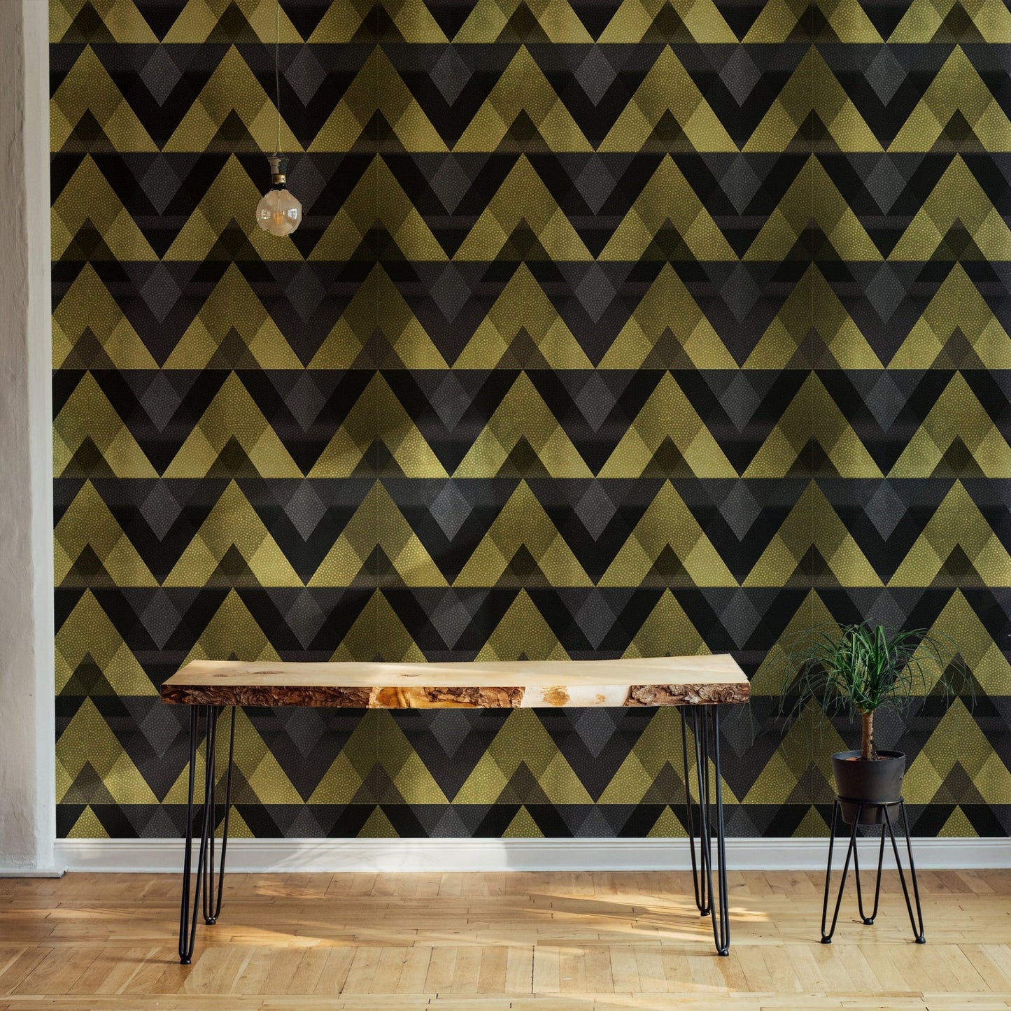 Workspace featuring gold zigzag wallpaper and dark industrial desk.