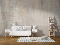 Playroom wall mural featuring golden and grey hanging leaves with white toys.